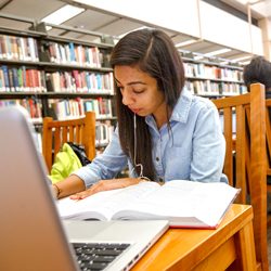 Student studying on the fourth floor of the library